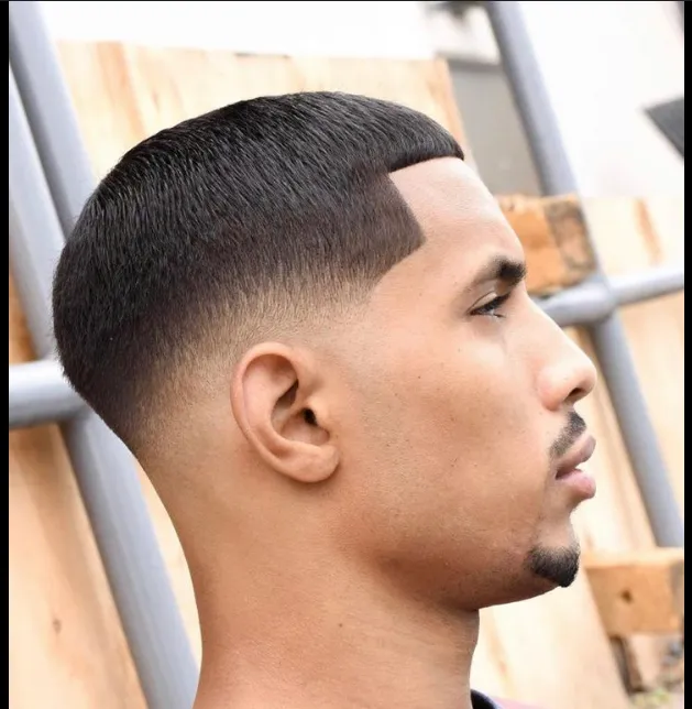 A clean taper fade seen in profile after a cut